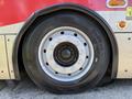 A close-up of a 2016 Grande West Vicinity bus wheel with a silver rim and black tire showing tread details and valve stem