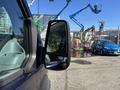 A 2016 Ford Transit 150 with a side mirror visible in the foreground