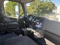 Interior view of a 2022 Freightliner M2 106 showing the driver's seat dashboard and gear shift area