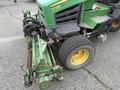 A 2009 John Deere 2653B Precision with green and yellow detailing featuring a mower attachment at the front and visible hydraulic lines and tires