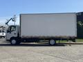 A 2018 Hino 195 box truck with a white cargo area and black cab parked on a pavement