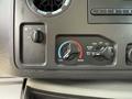 Dashboard controls of a 2013 Ford Econoline with knobs for fan speed temperature and air circulation settings