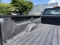 Interior view of the bed of a 2016 Chevrolet Silverado 2500HD with textured surface and wheel well indentation