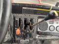 Close-up of the control panel of a 2010 Kubota RTV 900 featuring gear shifts for 4WD and 2WD along with a gear lever and various operational switches
