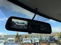 A rearview mirror displaying a video feed of a 2023 GMC Savana in front of it