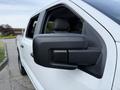 Close-up of the side mirror of a 2021 Ford F-150 showing its sleek design and black casing