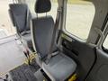 Interior of a 2009 Toyota Hiace featuring a single gray fabric seat with a seatbelt and adjustable headrest positioned in an upright position