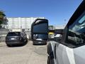 A 2017 Ford F-550 with a large side mirror reflecting nearby vehicles