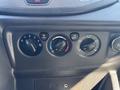 Control panel of a 2016 Ford Transit 150 featuring climate control knobs for fan speed temperature and air conditioning settings