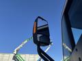 Close-up of a side mirror from a 2022 Lion Lion6 featuring an integrated signal light and reflective surface