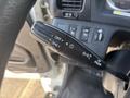 A close-up of the control stalk in a 2012 Hino 338 with buttons for headlights turn signals and wiper controls