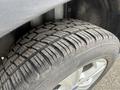 Close-up of a tire on a 2014 Ford Escape showing tread patterns and a silver alloy wheel