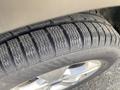 A close-up view of a tire on a 2015 Ford Escape showcasing the tread pattern and rubber details