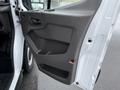 Interior door panel of a 2022 Ford Transit with a handle and storage compartment