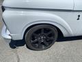 A close-up view of a 1962 Ford 2WHDR featuring a black wheel with a five-spoke design and low-profile tire