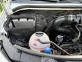 Under the hood of a 2017 Mercedes-Benz Sprinter showcasing the engine components including an air filter battery fluid reservoir and various hoses