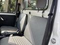Interior of a 2010 Daihatsu Hijet featuring two fabric seats with a grey geometric pattern and adjustable headrests