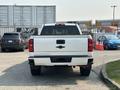 White 2017 Chevrolet Silverado 1500 viewed from the rear showcasing the tailgate and Chevrolet emblem