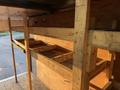 2015 GMC Savana with a wooden shelving unit built inside featuring several open storage compartments