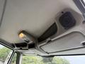 View of the interior roof of a 2012 International TerraStar showing overhead storage compartments and speakers