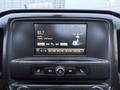 Dashboard display of a 2017 GMC Sierra 3500HD showing a radio station tuned to 93.7 FM with song information and temperature reading