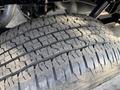 A close-up view of a worn tire tread from a 2021 Ford F-150 showing intricate patterns and grooves on the surface