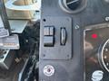 Close-up of the control panel of a 2008 Workhorse W62 featuring two switches a dial and a button labeled set parking brake