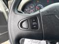 Steering wheel controls of a 2013 International DuraStar 4300 featuring buttons for air horn cruise and throttle settings