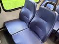 Two upholstered blue seats in a vehicle interior designed for passenger comfort