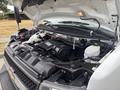 The image shows the engine compartment of a 2020 Chevrolet Express with exposed components including the air intake battery and various hoses and wiring