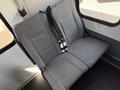 A gray upholstered bench seat with seat belts installed in the back of a 2021 Ford Econoline van