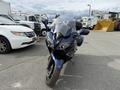 A 2016 Yamaha FJR1300AE motorcycle with a dark blue body and a large windshield positioned in front of the camera