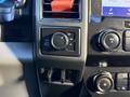 Control panel of a 2020 Ford F-350 featuring a four-wheel drive selector knob and audio controls