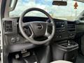 Interior view of a 2018 GMC Savana focusing on the dashboard steering wheel and control panel