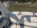 A 2013 Larson 238 boat featuring a spacious seating area and a sleek design