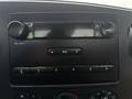 Dashboard of a 2006 Ford F-450 featuring a car audio system with buttons for volume and tuning along with a digital display