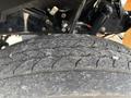 A close-up view of a worn tire from a 2020 Lion Lion6 showcasing tire tread patterns and surface texture
