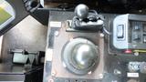 A close-up view of the control panel of a 2003 International 5600i featuring a round gear shift knob and various buttons and switches