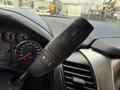 The interior of a 2017 Chevrolet Tahoe showing the gear shift lever with buttons for gear selection and cruise control settings