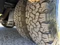 Close-up of the rugged tires of a 2013 Chevrolet Express showcasing deep treads designed for improved traction and durability