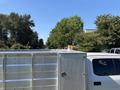 A white 2019 Ford F-550 with a silver truck bed and an orange beacon light on top