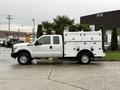 A white 2015 Ford F-350 SD with a utility body featuring multiple compartments and toolboxes on the truck bed
