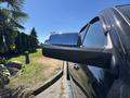 Close-up of the side mirror of a 2015 RAM 1500 showing a shiny chrome finish and a black housing