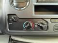 Dashboard controls of a 2023 Ford E-450 featuring temperature and fan settings with dials for cool, warm, and air conditioning functions