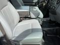 Interior view of a 2011 Ford F-350 SD featuring a gray fabric front seat with a center console and seatbelt visible