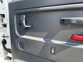 Interior door panel of a 2005 GMC C7500 Topkick featuring a handle lock button and speaker grille