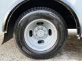 Close-up of a silver wheel on a 2019 Chevrolet Express featuring a five-bolt pattern and Michelin tire with visible tread details.