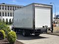 A 2018 Hino 195 box truck with a white cargo area parked on a paved surface