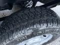 Close-up of a rugged tire tread on a 2023 Ford F-250 showcasing deep grooves for traction and stability