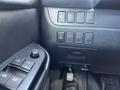 Interior controls of a 2018 Toyota Highlander including window switches and various system buttons